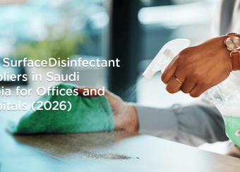 Person disinfecting an office desk with surface disinfectant spray in Saudi Arabia
