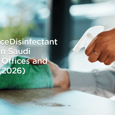Person disinfecting an office desk with surface disinfectant spray in Saudi Arabia