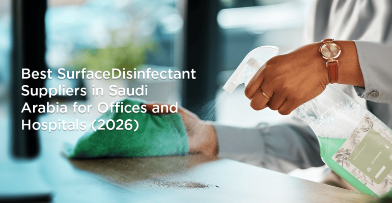 Person disinfecting an office desk with surface disinfectant spray in Saudi Arabia
